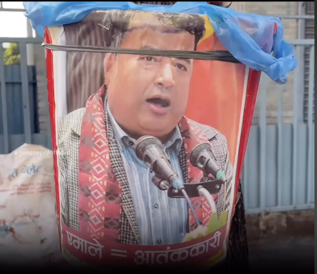 Dustbin in Pokhara with Basnet photo pasted on it, UML equals Terrorist